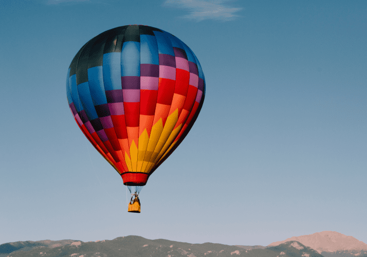 hot air balloon flying on a clear blue sky