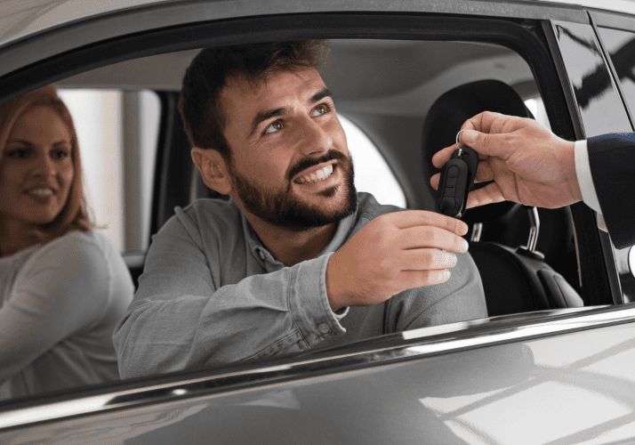 Out-Of-State Title Only man receiving car keys to a car he just purchased
